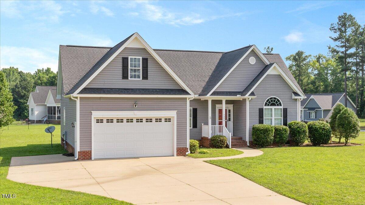 7326 Red Fox Road Bailey, NC 27807 - Photo 3 of 26 a front view of a house with a yard and garage