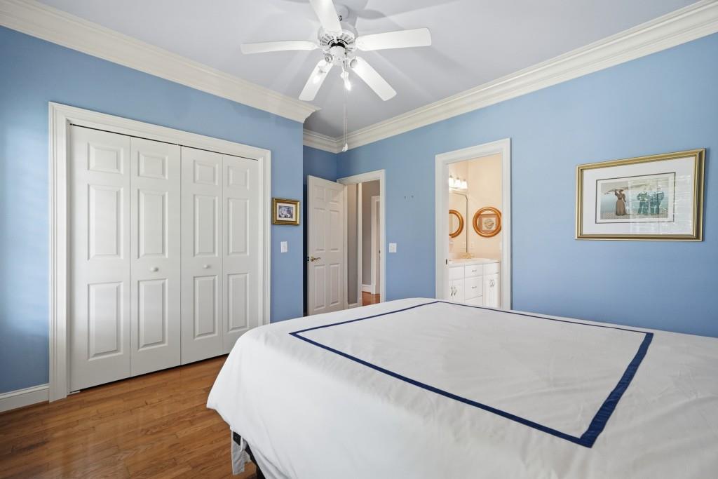 774 Bray Road Southwest Calhoun, GA 30701 - Photo 39 of 106 a bedroom with a large bed and a chandelier