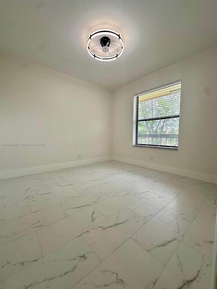 21911 Lake Forest Circle, Unit 202 Boca Raton, FL 33433 - Photo 5 of 14 an empty room with windows and fan