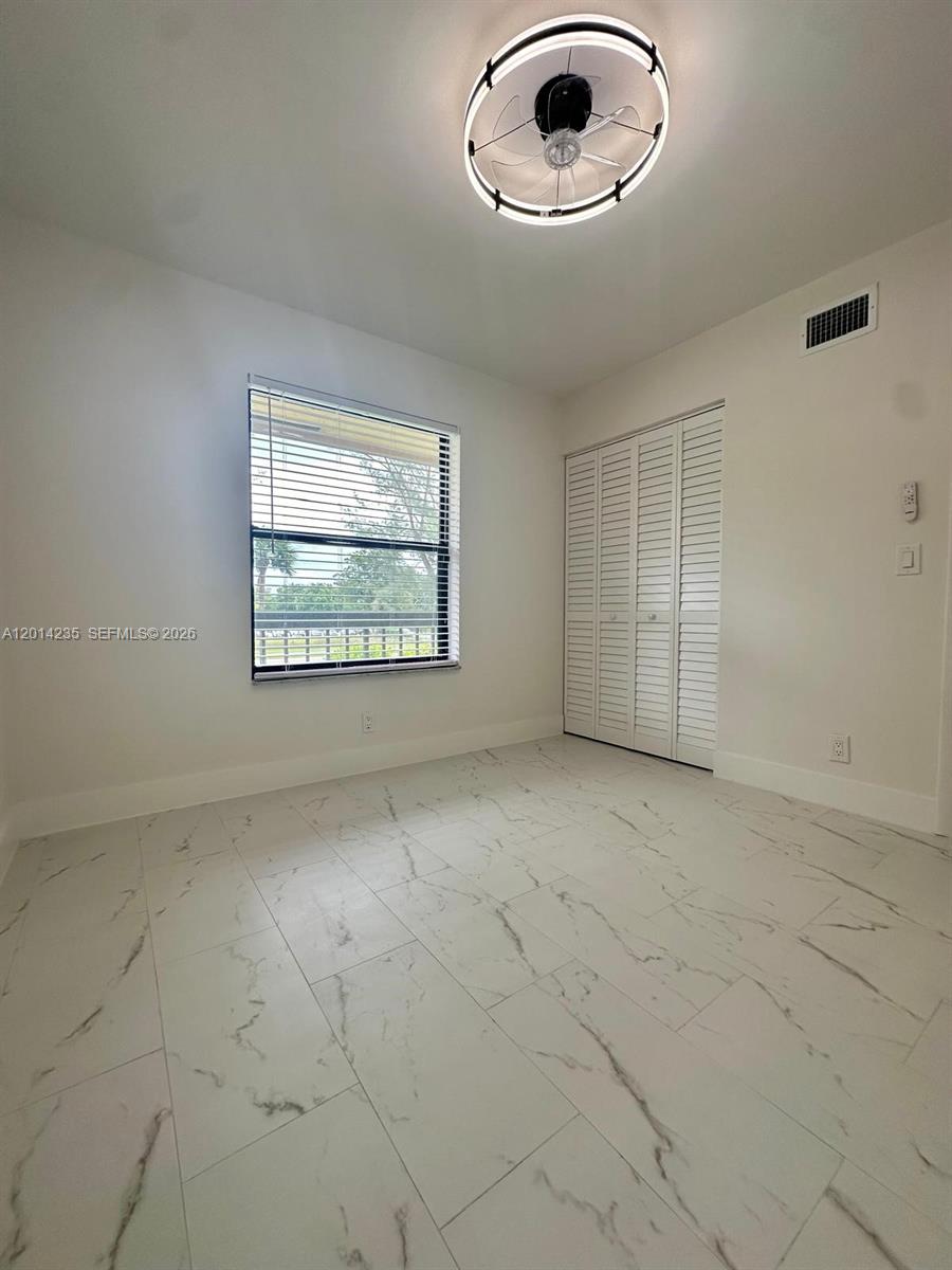 21911 Lake Forest Circle, Unit 202 Boca Raton, FL 33433 - Photo 6 of 14 an empty room with a empty space and windows