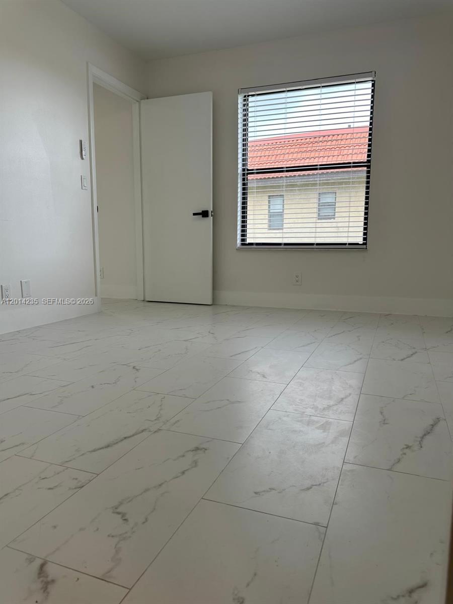 21911 Lake Forest Circle, Unit 202 Boca Raton, FL 33433 - Photo 8 of 14 a view of an empty room with a window