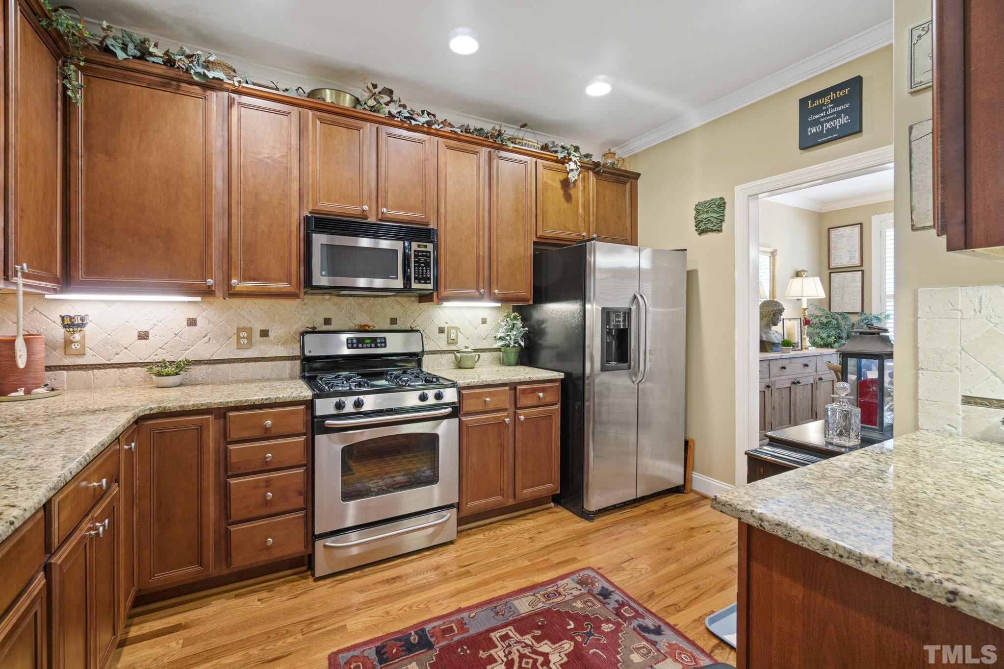 641 Canvas Drive Wake Forest, NC 27587 - Photo 11 of 37 a kitchen with stainless steel appliances granite countertop a refrigerator stove and sink