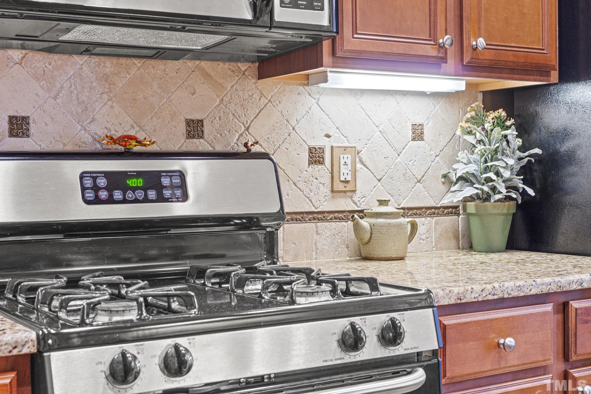 641 Canvas Drive Wake Forest, NC 27587 - Photo 12 of 37 a stove top oven sitting inside of a kitchen