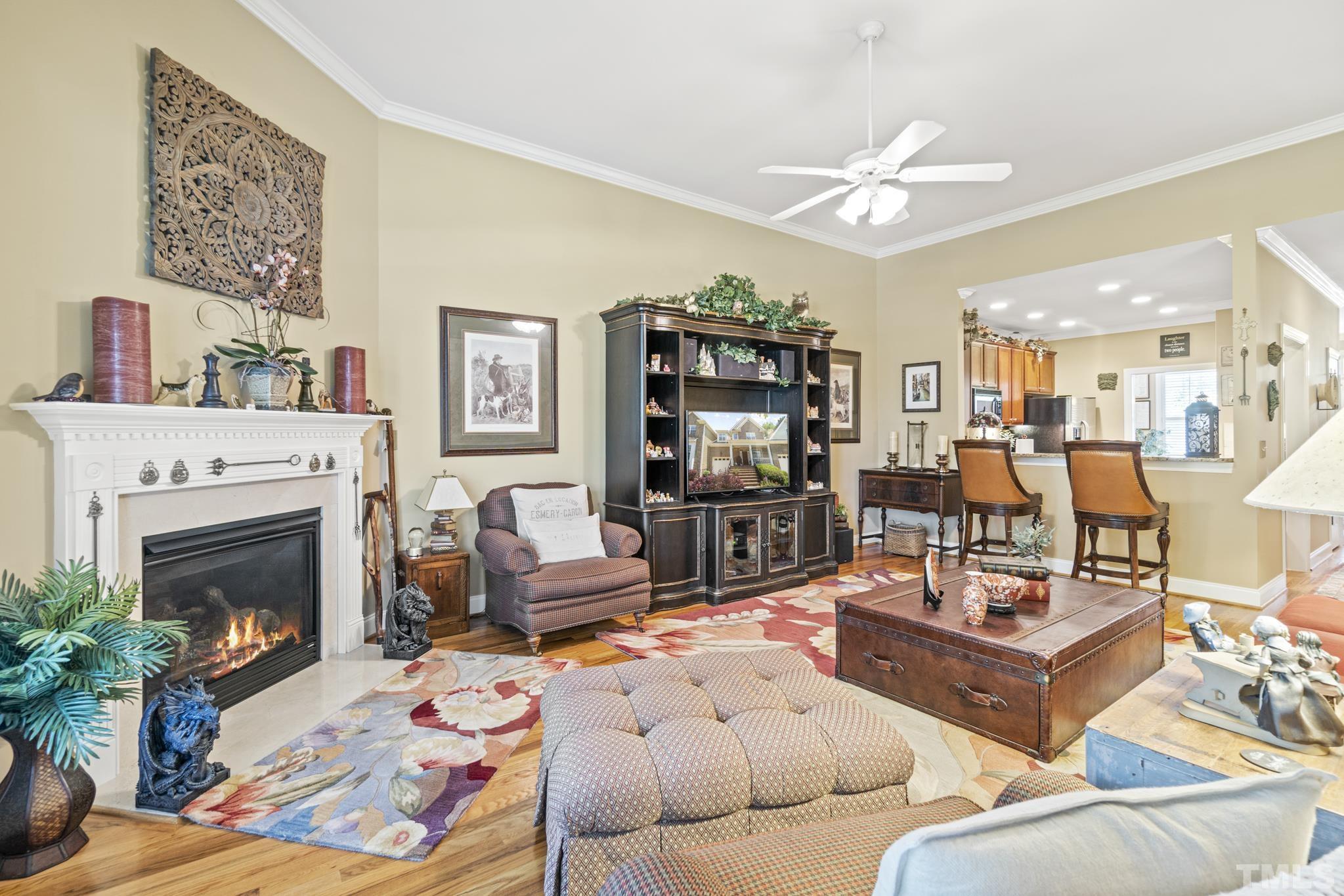 641 Canvas Drive Wake Forest, NC 27587 - Photo 16 of 37 a living room with furniture a fireplace and a flat screen tv