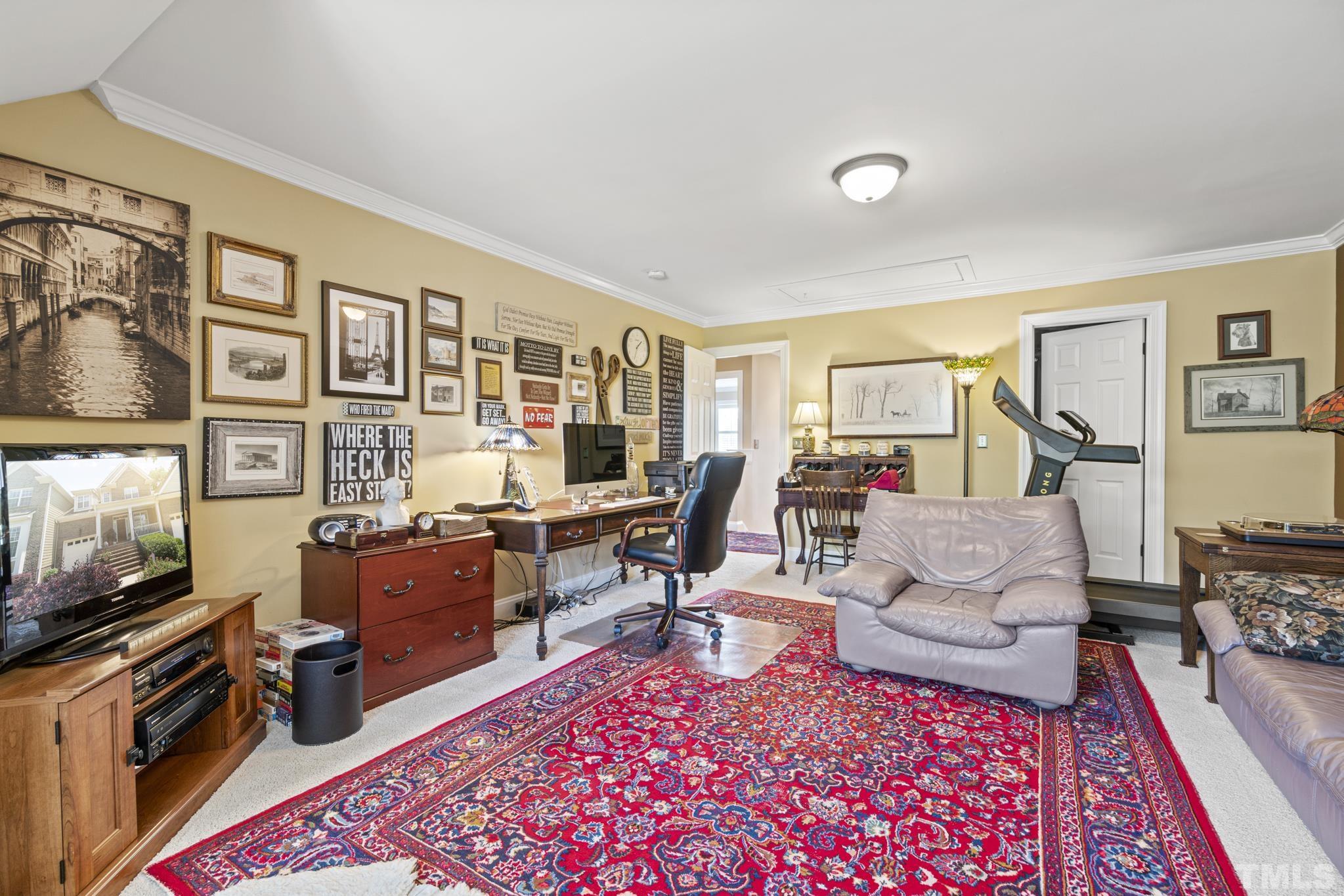 641 Canvas Drive Wake Forest, NC 27587 - Photo 23 of 37 a living room with furniture a rug and a flat screen tv