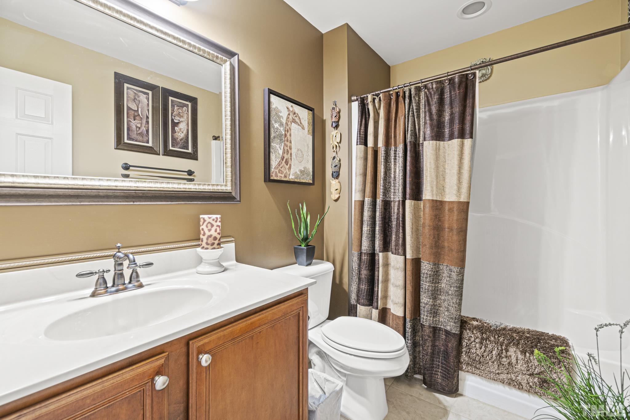 641 Canvas Drive Wake Forest, NC 27587 - Photo 24 of 37 a bathroom with a sink a toilet and shower