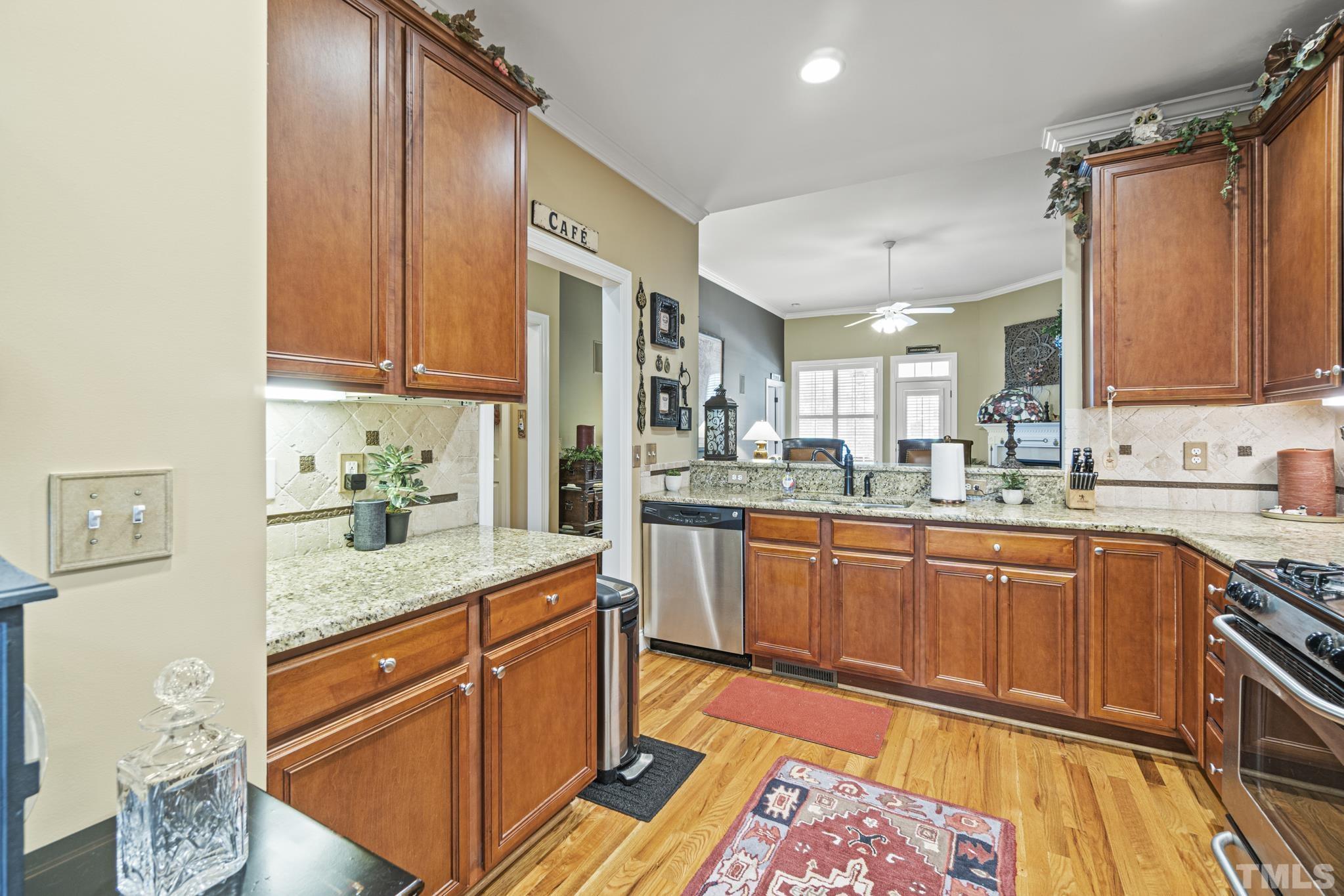 641 Canvas Drive Wake Forest, NC 27587 - Photo 9 of 37 a kitchen with stainless steel appliances granite countertop a sink stove and cabinets