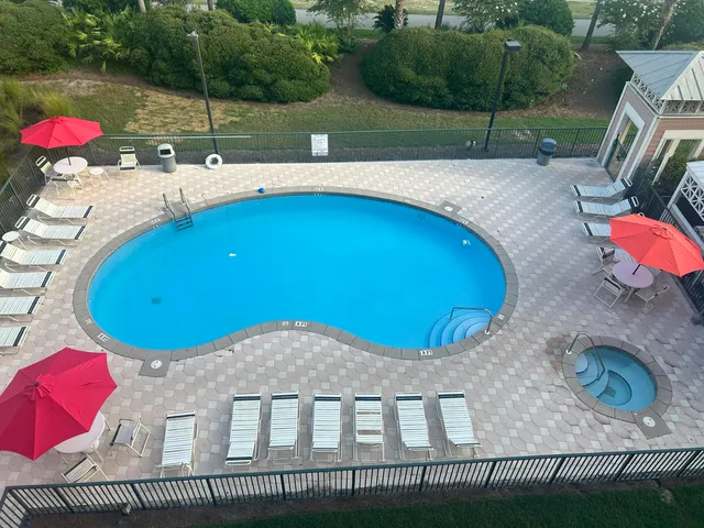 an aerial view of a house with outdoor space and parking