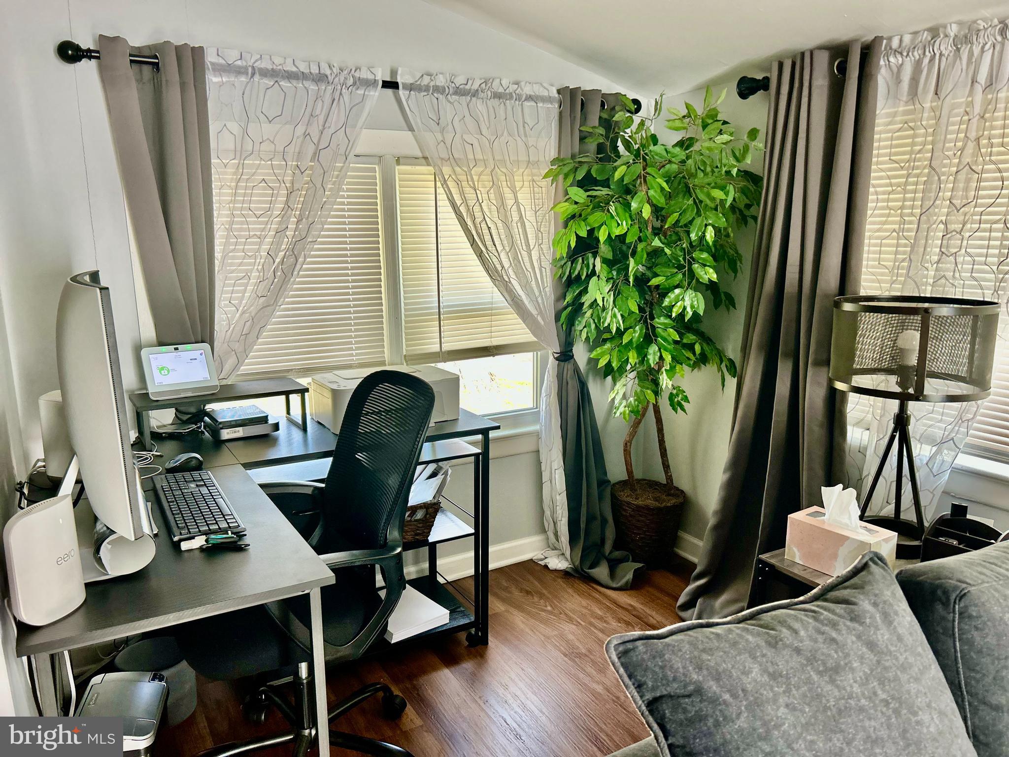 252 G Street Carneys Point, NJ 08069 - Photo 5 of 8 a view of a workspace with furniture and a potted plant