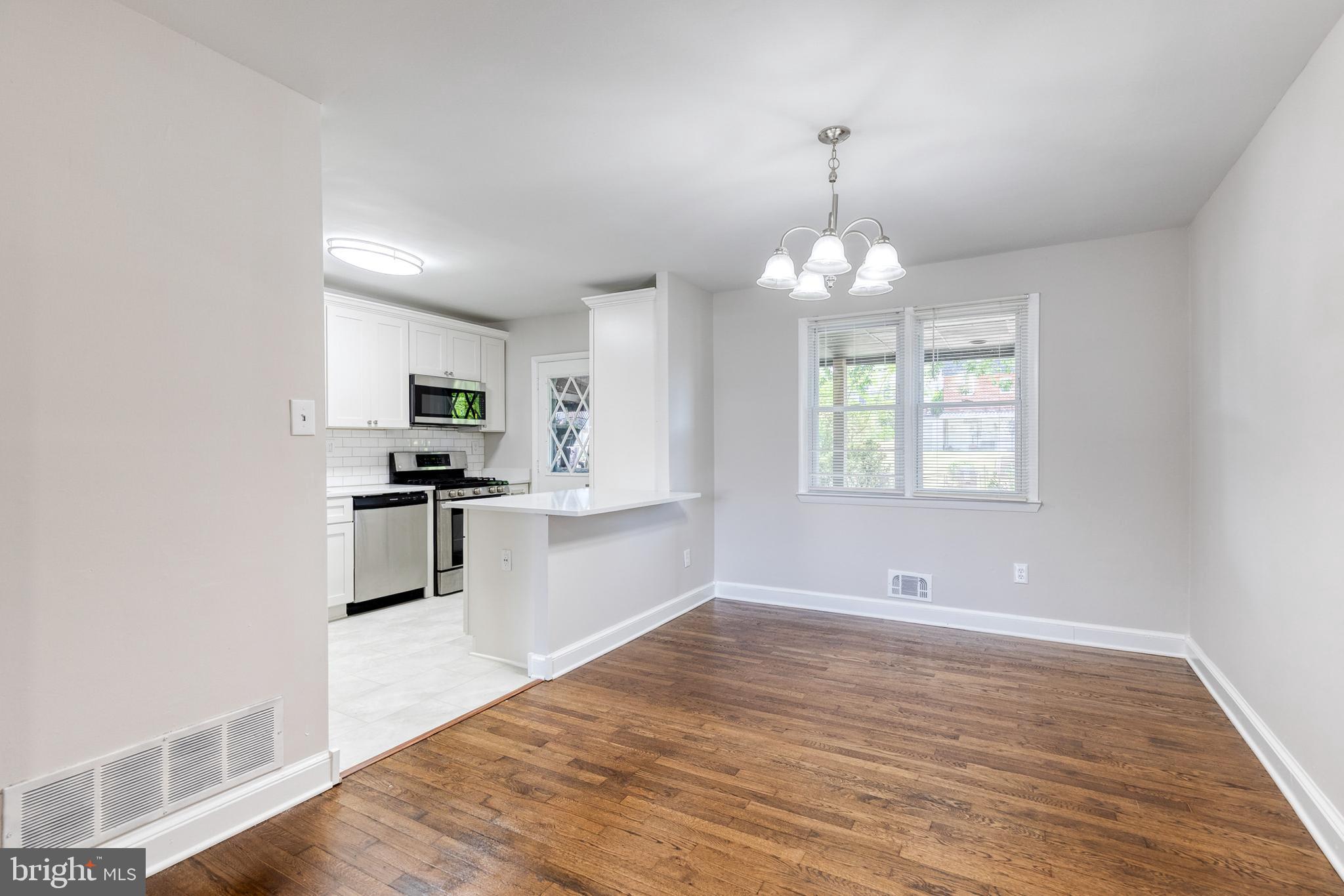 5649 Utrecht Road Baltimore, MD 21206 - Photo 16 of 42 a view of a kitchen with wooden floor and electronic appliances