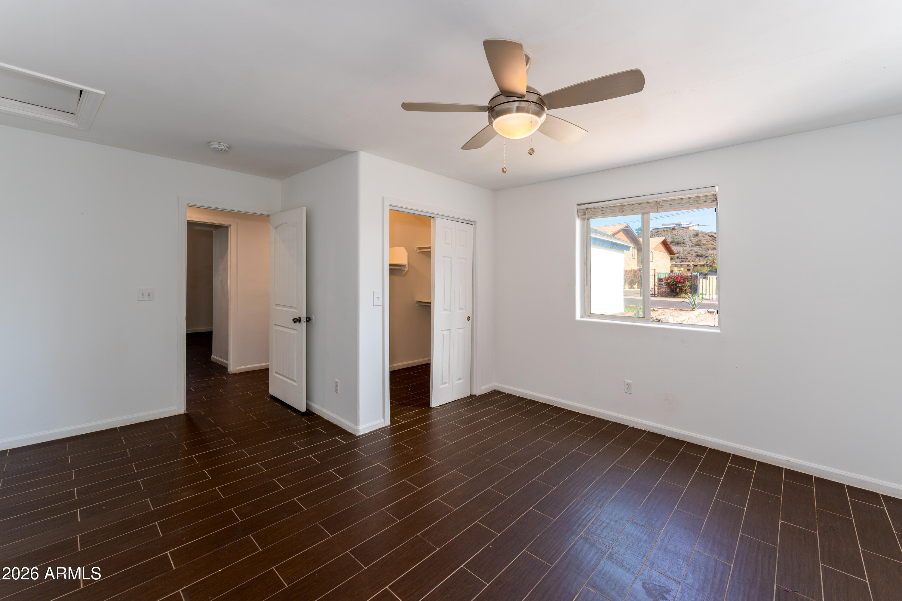 9616 North 11th Avenue Phoenix, AZ 85021 - Photo 12 of 32 a view of a big room with wooden floor and windows