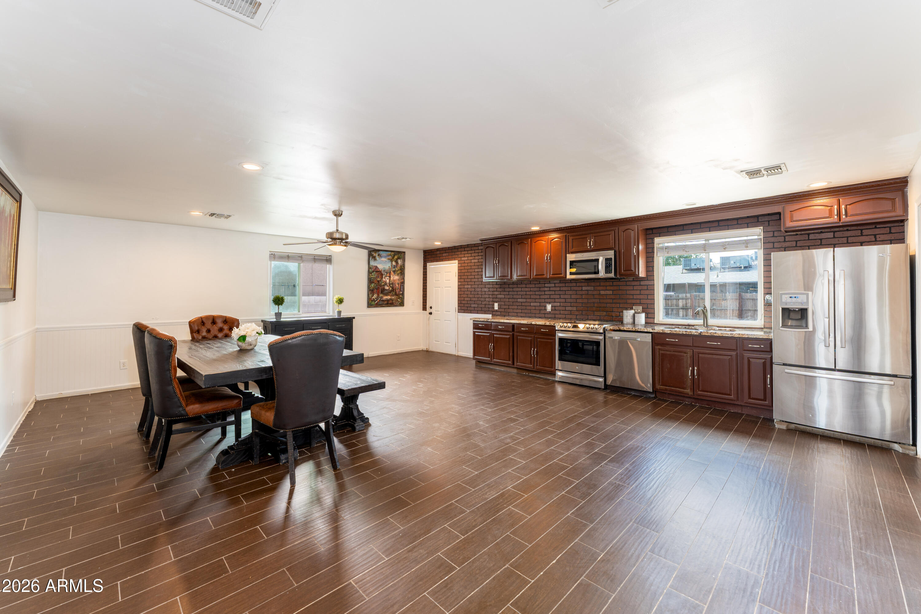 9616 North 11th Avenue Phoenix, AZ 85021 - Photo 18 of 32 a living room with stainless steel appliances kitchen island granite countertop furniture wooden floor and a view of kitchen