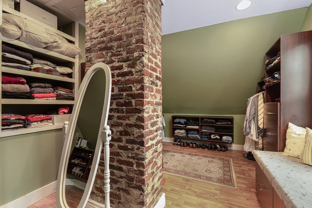 194 Washington Street Boxford, MA 01921 - Photo 27 of 35 a view of walk in closet with clothes and shoes