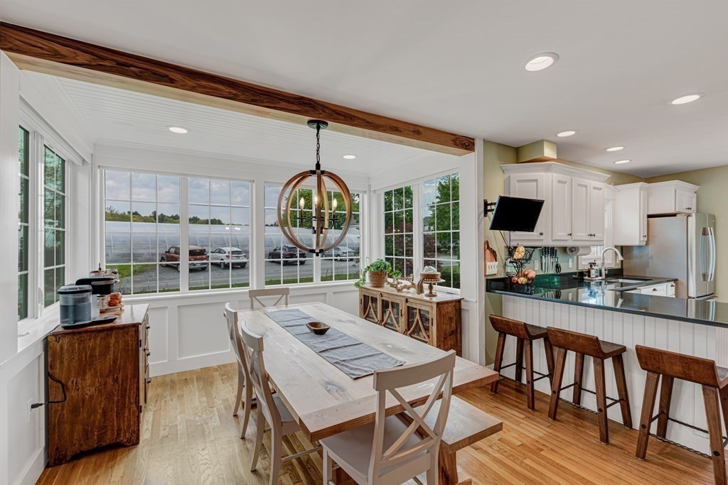 194 Washington Street Boxford, MA 01921 - Photo 5 of 35 a kitchen with stainless steel appliances kitchen island granite countertop a table chairs and a refrigerator