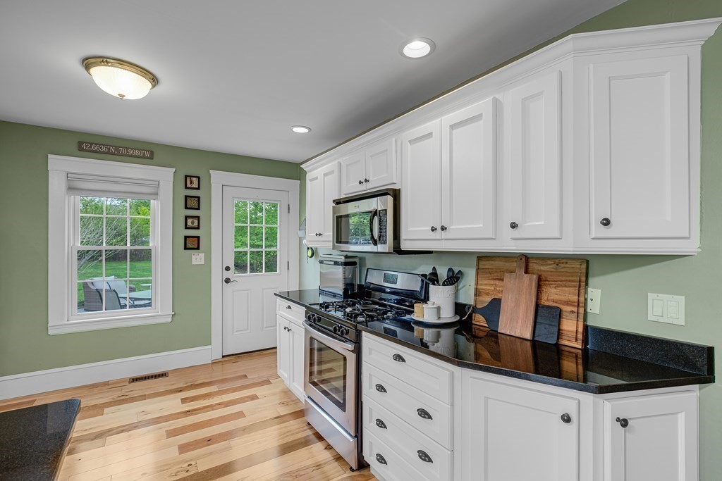 194 Washington Street Boxford, MA 01921 - Photo 7 of 35 a kitchen with granite countertop white cabinets and window