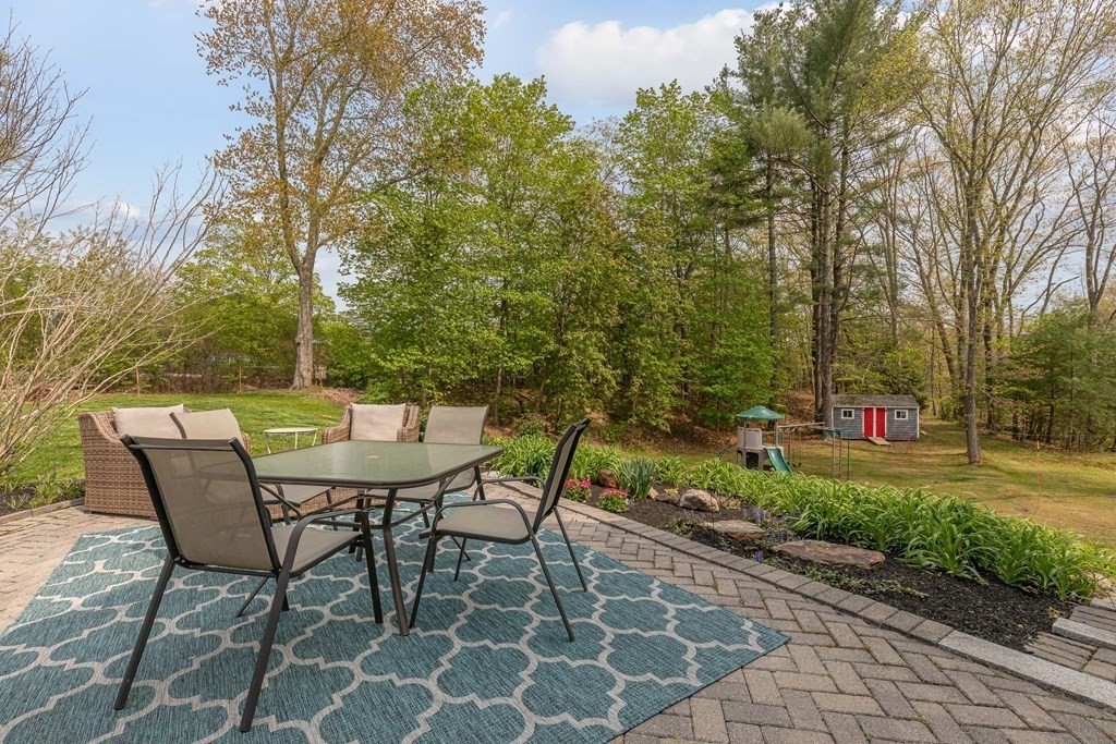 194 Washington Street Boxford, MA 01921 - Photo 8 of 35 a view of a chairs and table in the backyard