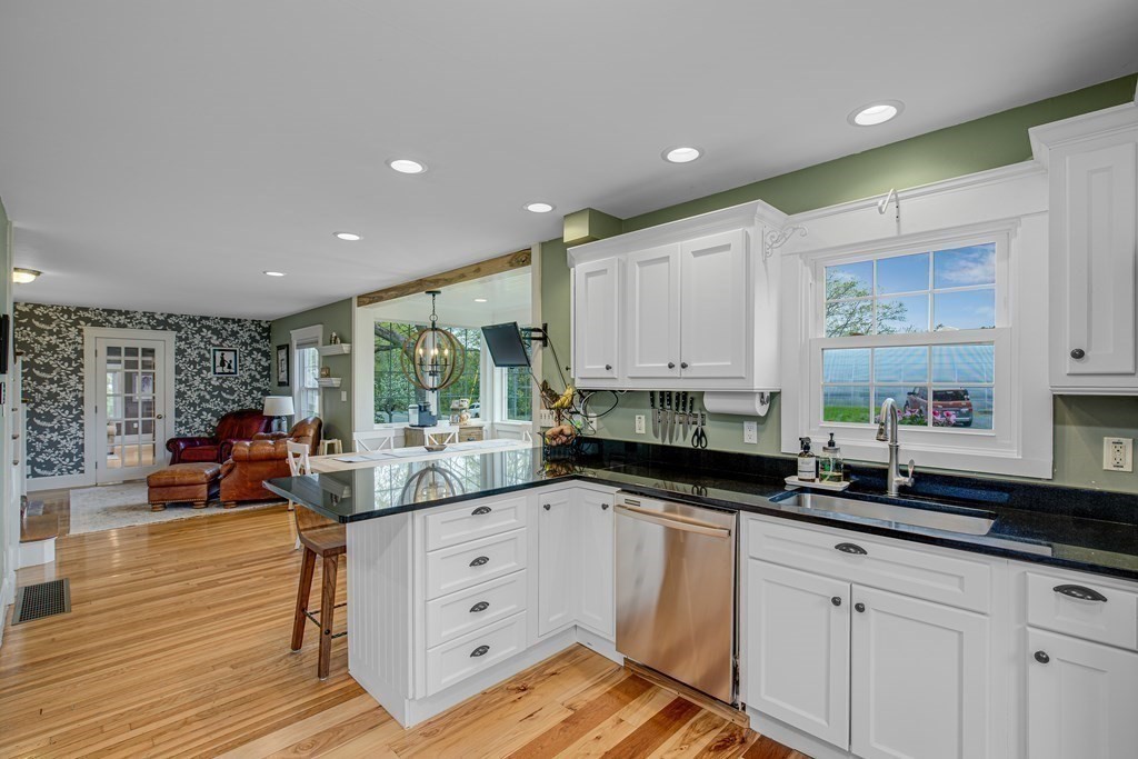 194 Washington Street Boxford, MA 01921 - Photo 10 of 35 a kitchen with white cabinets a sink dishwasher and a stove with wooden floor