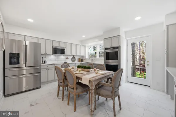 an empty room with wooden floor and large windows