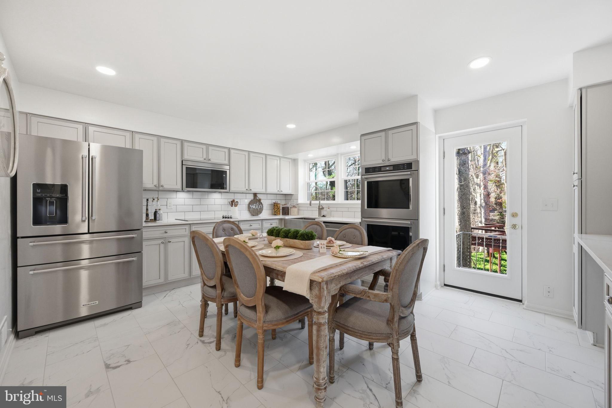 2827 Ellicott Street Northwest Washington, DC 20008 - Photo 11 of 56 a kitchen with stainless steel appliances a refrigerator stove microwave and cabinets