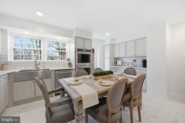 a view of an empty room with wooden floor and windows