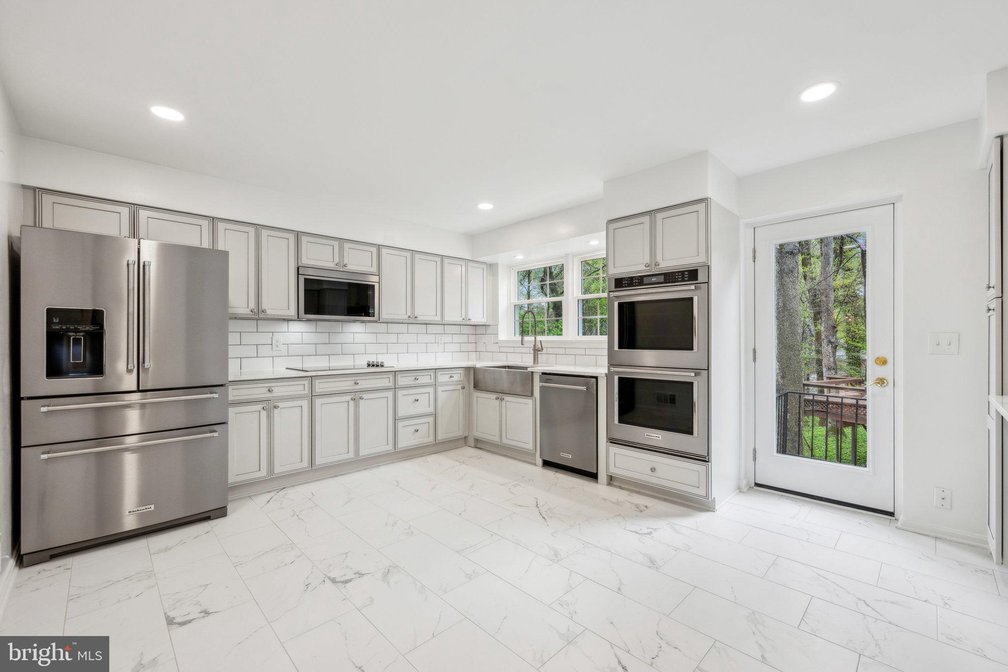2827 Ellicott Street Northwest Washington, DC 20008 - Photo 13 of 56 a kitchen with stainless steel appliances a refrigerator sink and stove