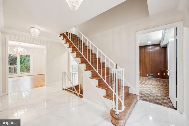 a view of entryway and hall with wooden floor