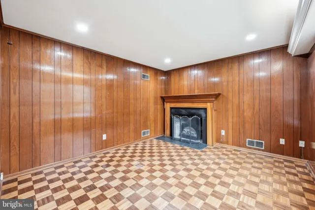 a big room with windows and fireplace