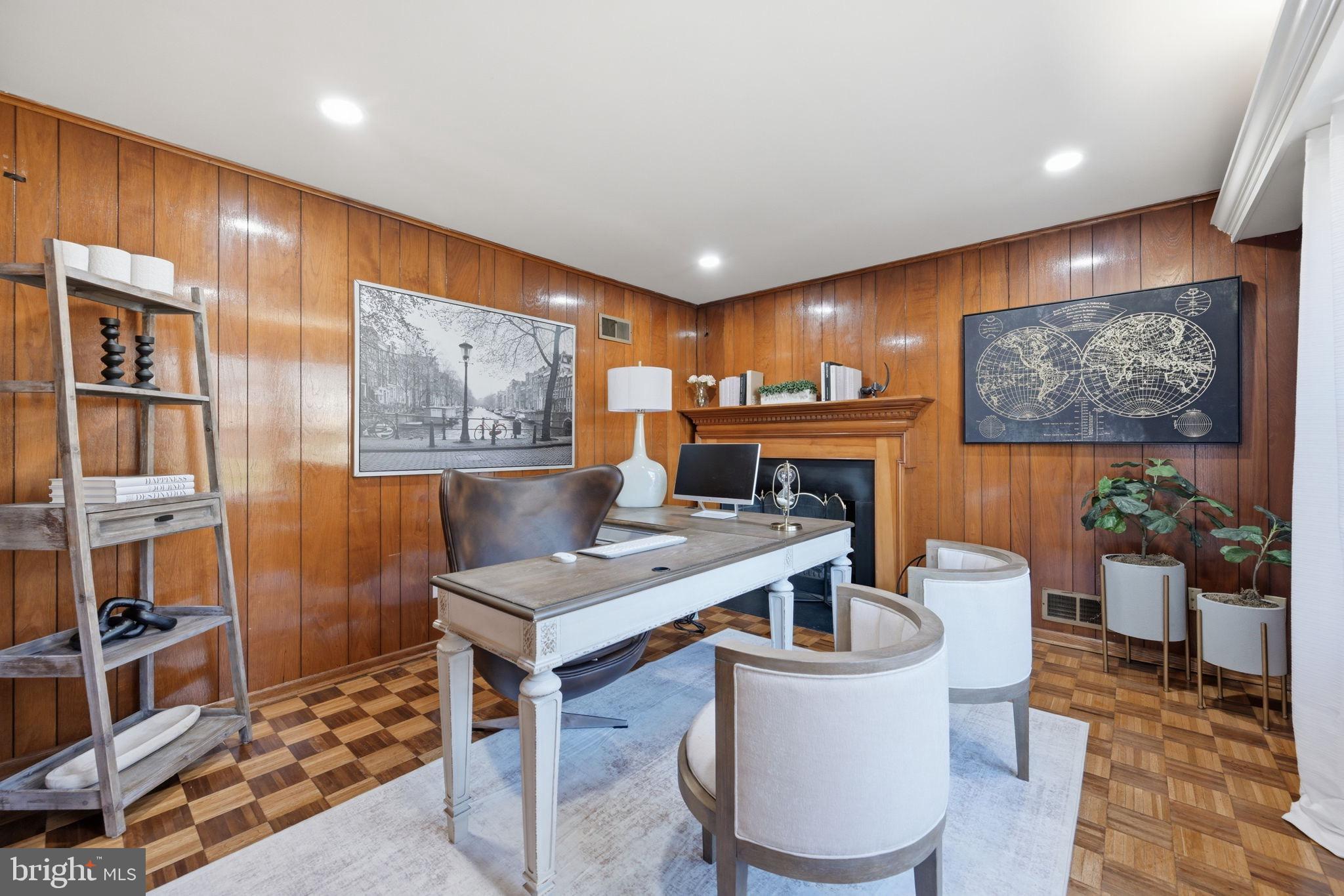 2827 Ellicott Street Northwest Washington, DC 20008 - Photo 18 of 56 a living room with furniture a piano and a bookshelf