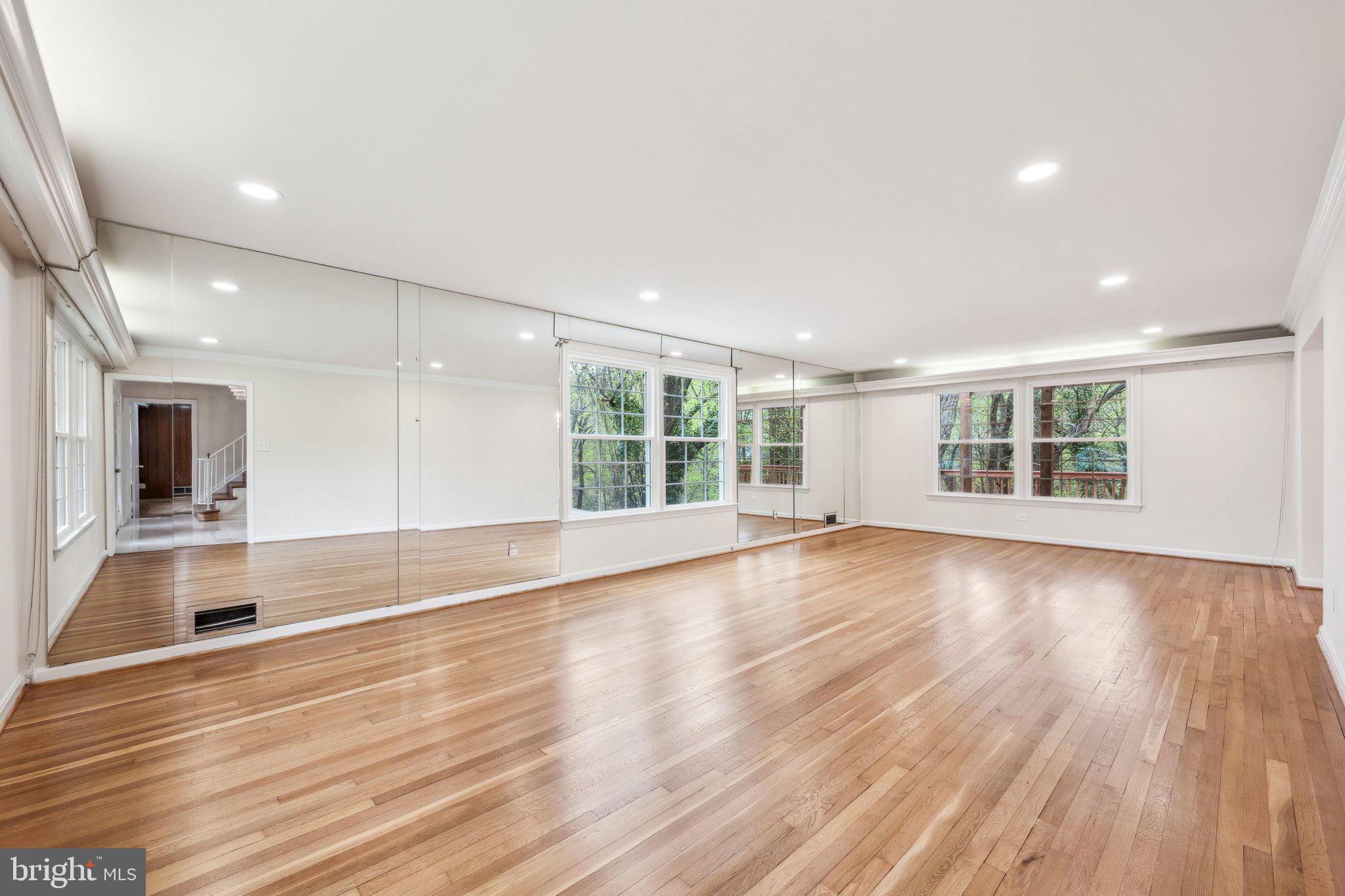 2827 Ellicott Street Northwest Washington, DC 20008 - Photo 23 of 56 an empty room with wooden floor and large windows