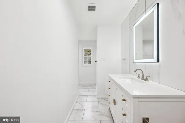 a bathroom with a sink a toilet and mirror