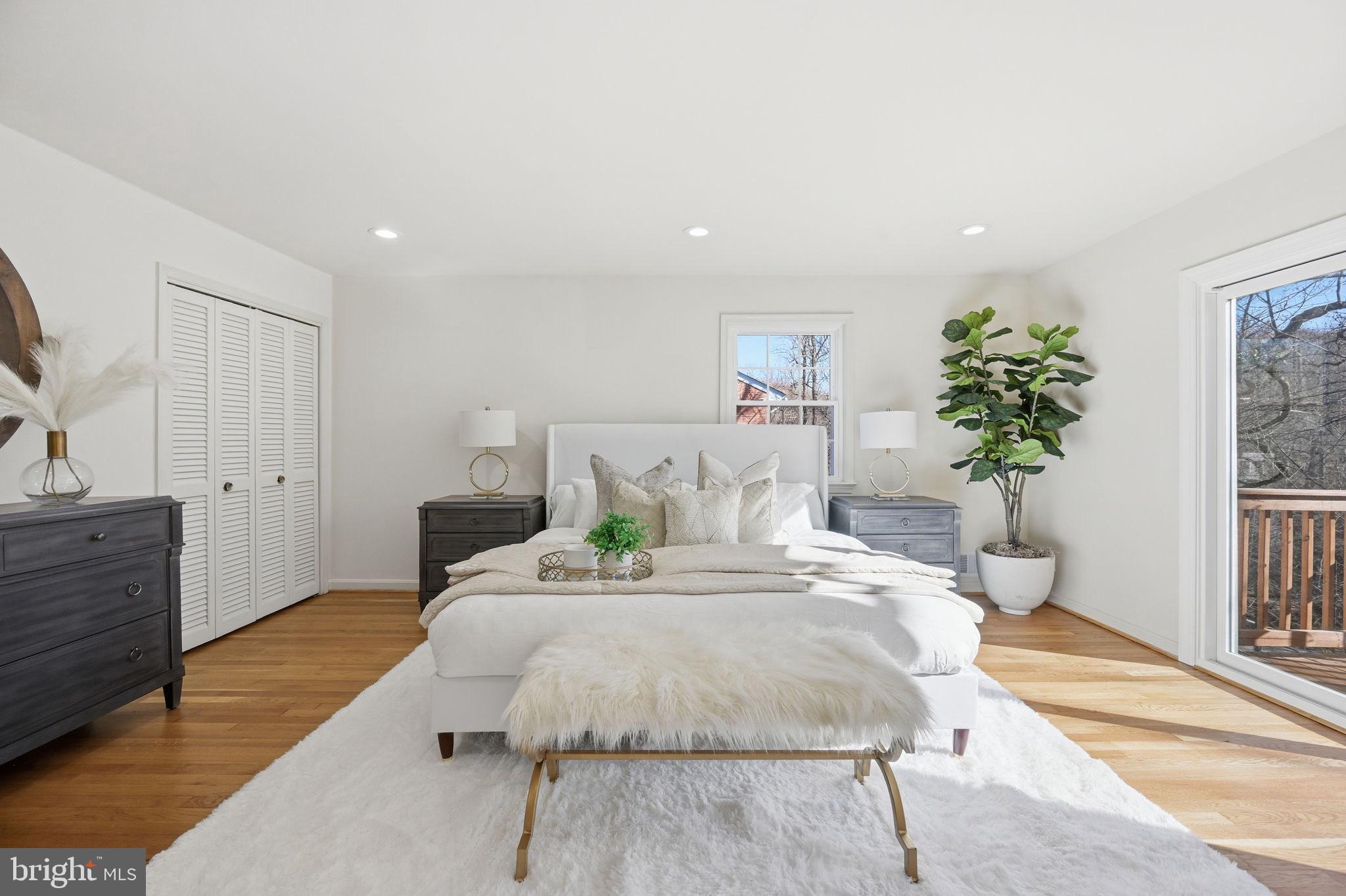 2827 Ellicott Street Northwest Washington, DC 20008 - Photo 25 of 56 a bedroom with a large bed and a potted plant