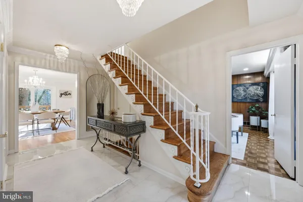a view of a dining room with furniture a chandelier and wooden floor