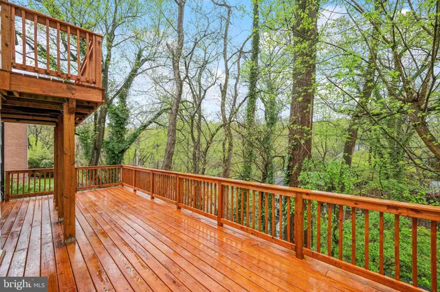 a view of balcony with wooden floor and fence