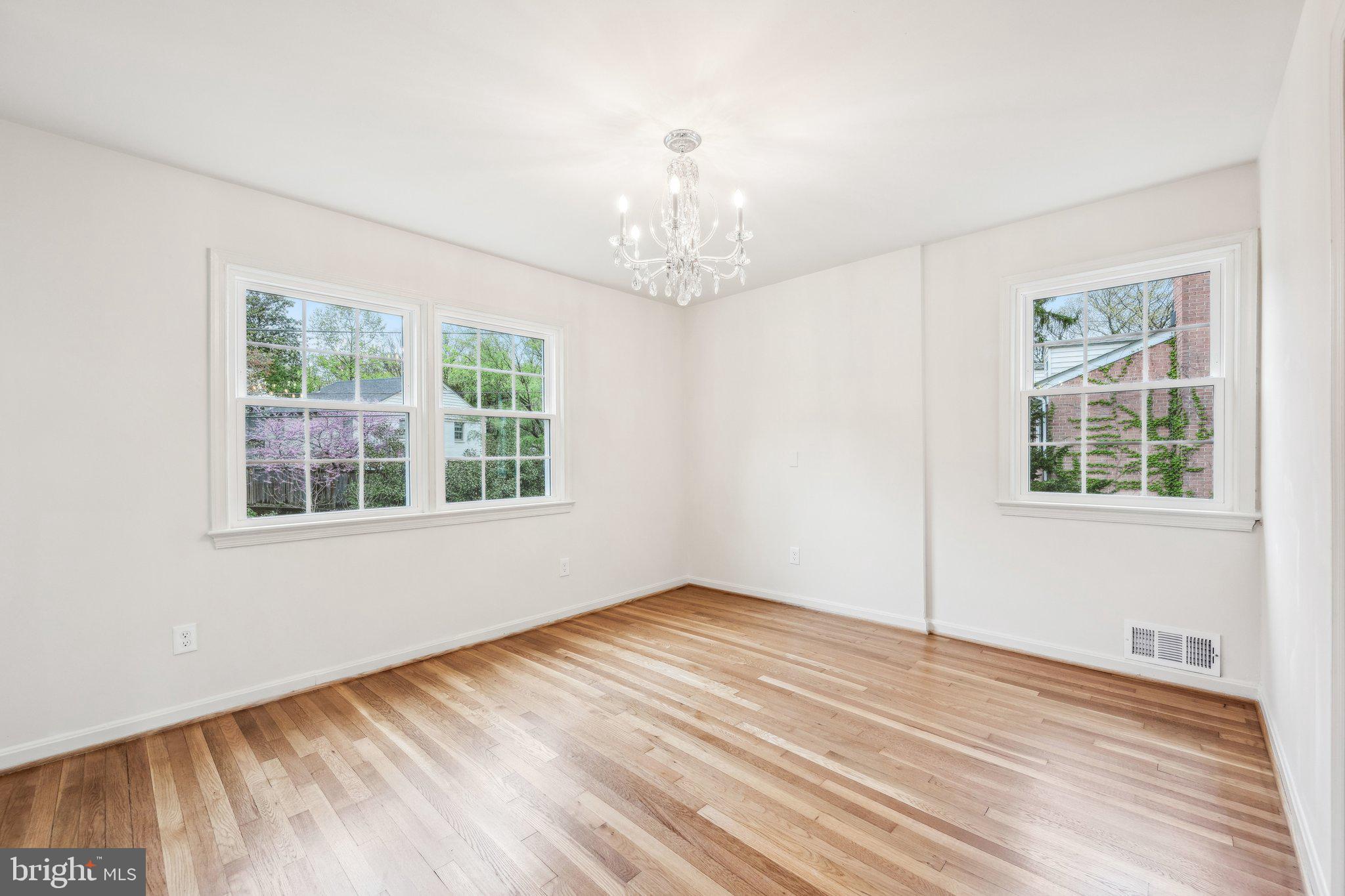 2827 Ellicott Street Northwest Washington, DC 20008 - Photo 42 of 56 a view of an empty room with wooden floor and a window