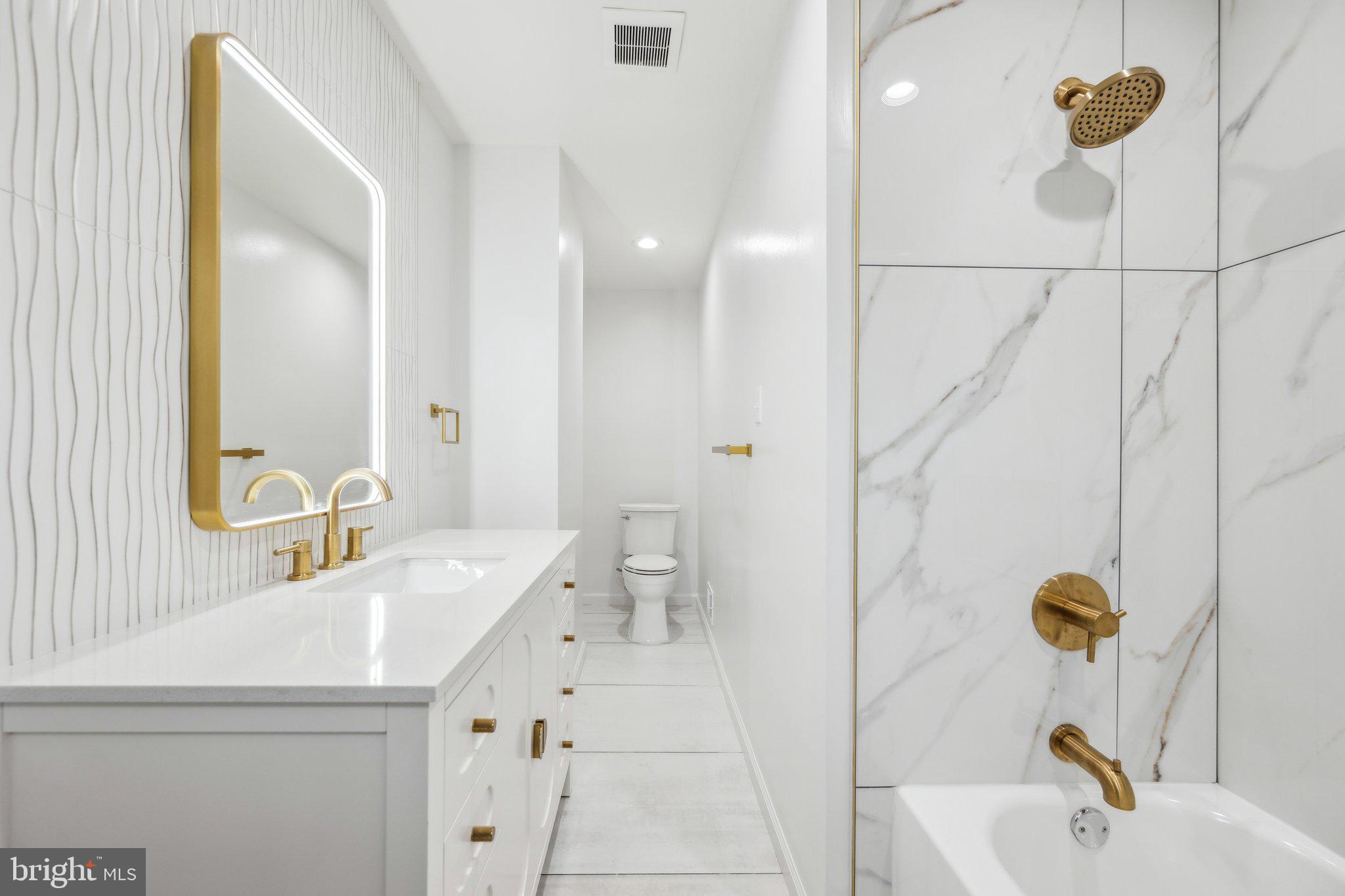2827 Ellicott Street Northwest Washington, DC 20008 - Photo 45 of 56 a bathroom with a sink and mirror with bathtub