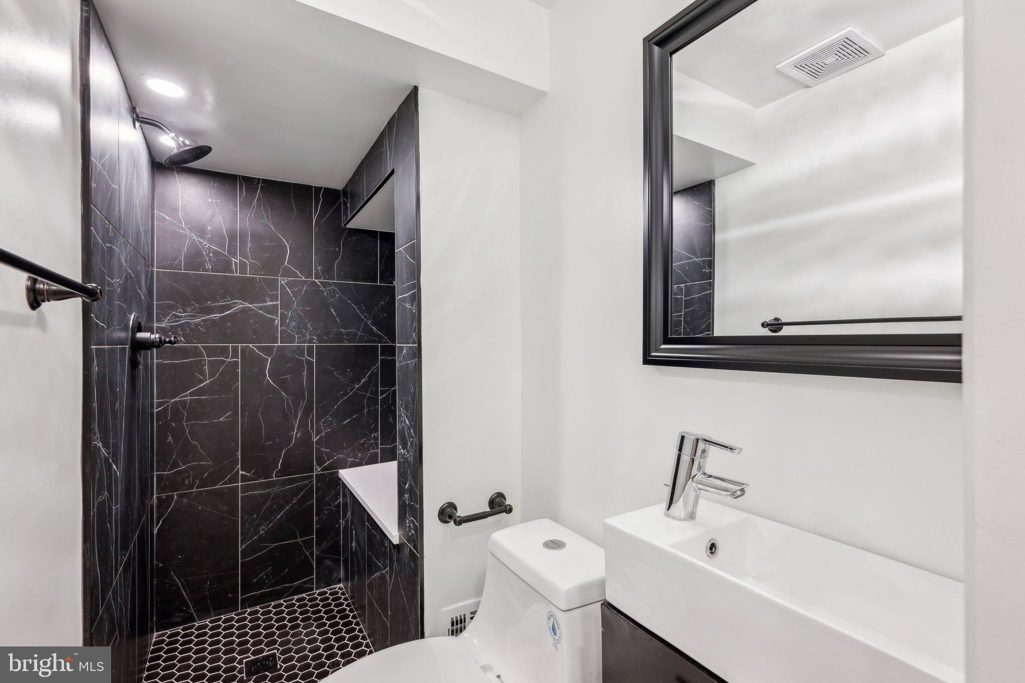 2827 Ellicott Street Northwest Washington, DC 20008 - Photo 47 of 56 a bathroom with a sink toilet and shower