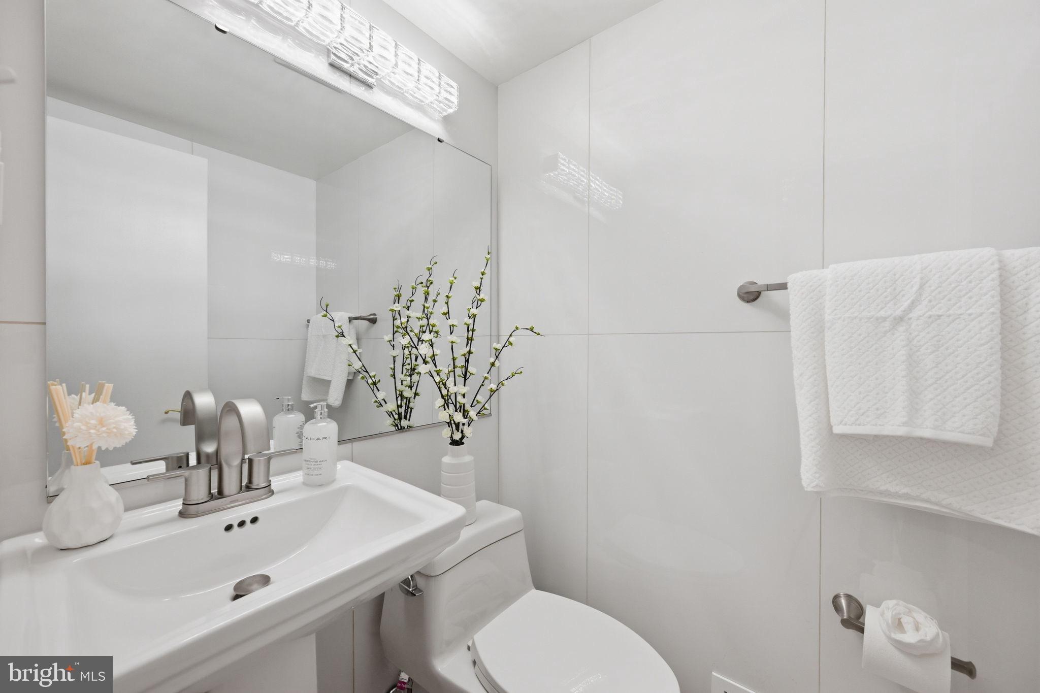 2827 Ellicott Street Northwest Washington, DC 20008 - Photo 52 of 56 a bathroom with a sink a toilet and mirror