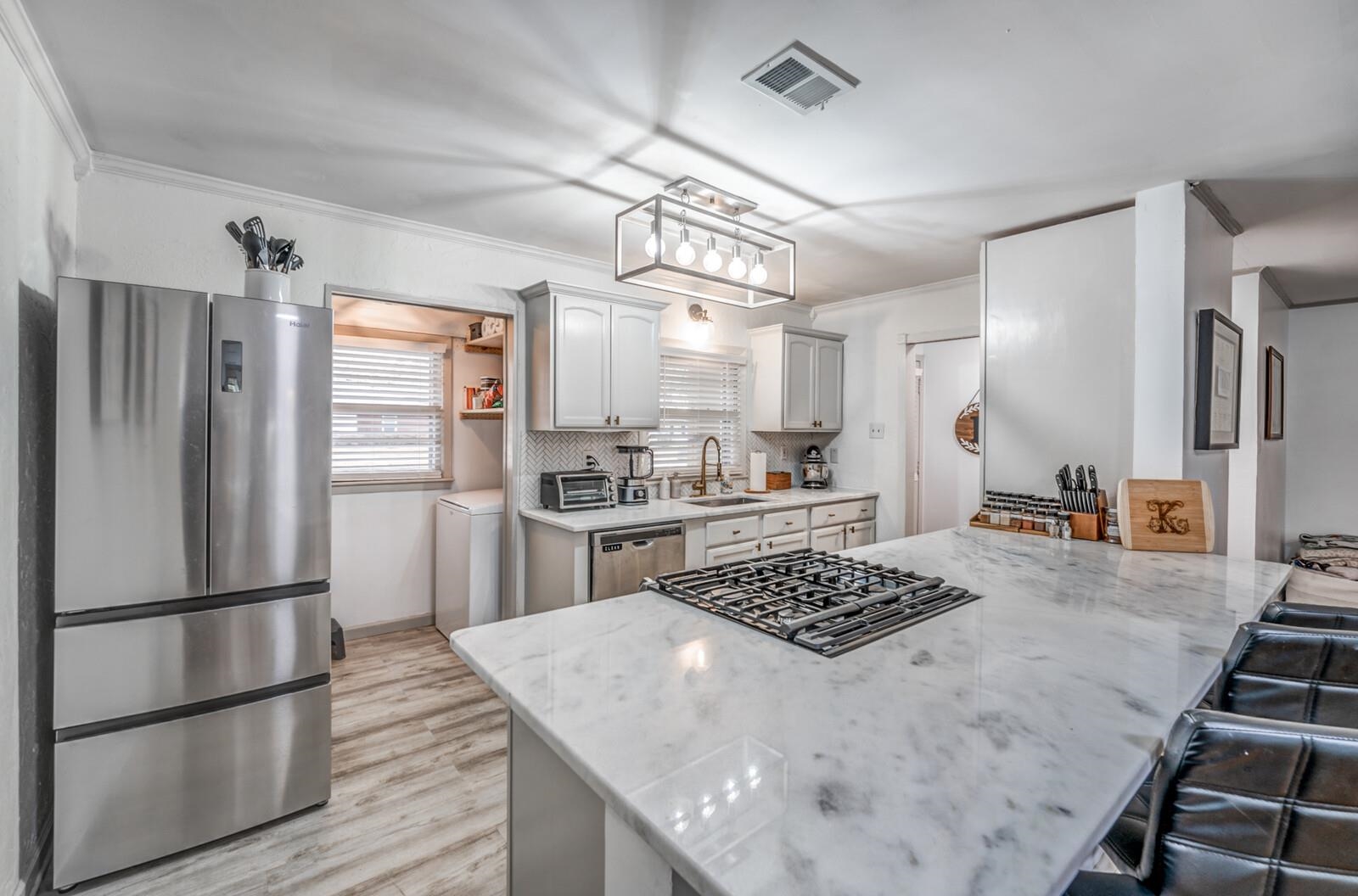 1297 Marcia Road Memphis, TN 38117 - Photo 1 of 32 a kitchen with a refrigerator and a stove top oven