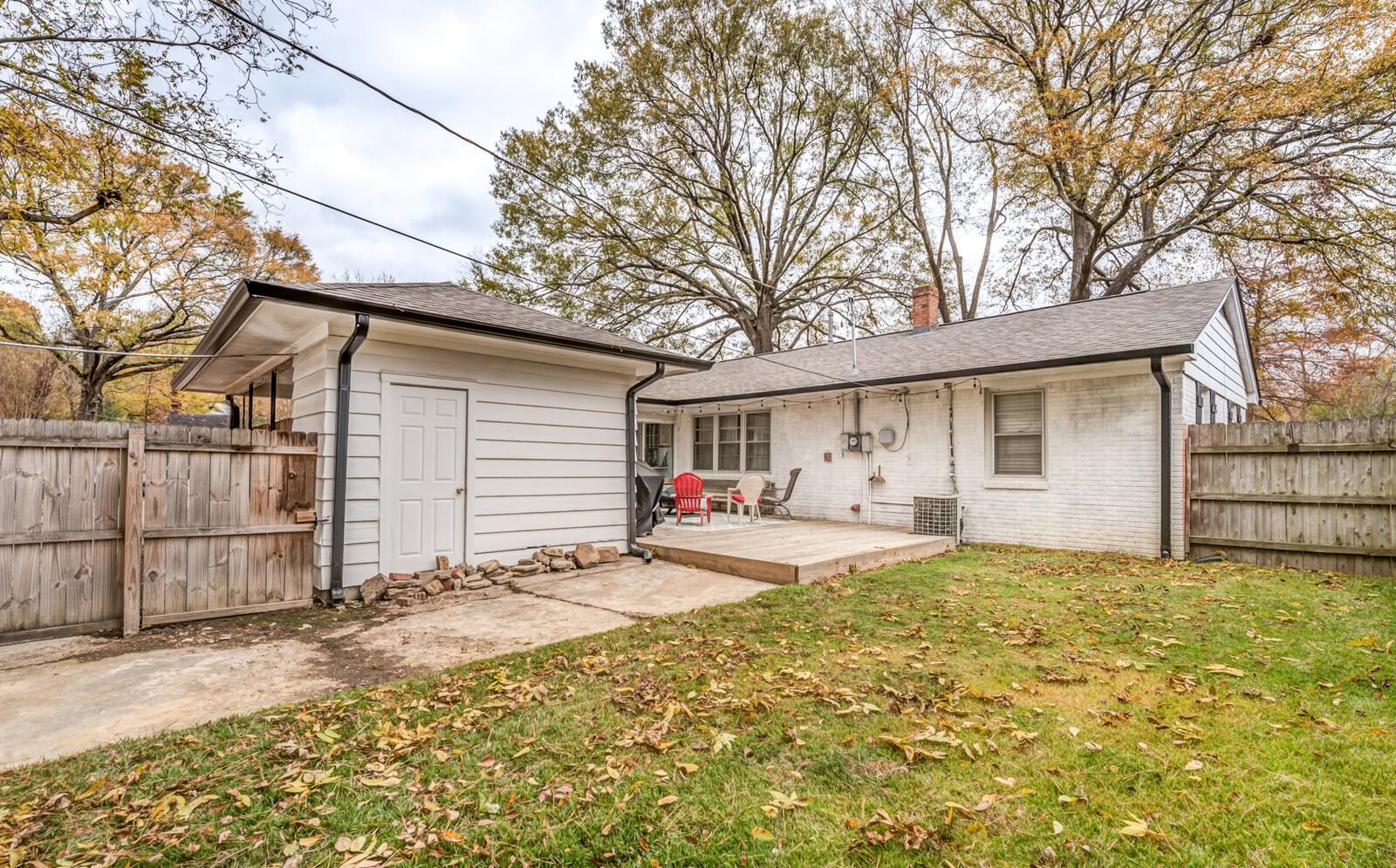 1297 Marcia Road Memphis, TN 38117 - Photo 29 of 32 a view of a house with a large tree and wooden fence