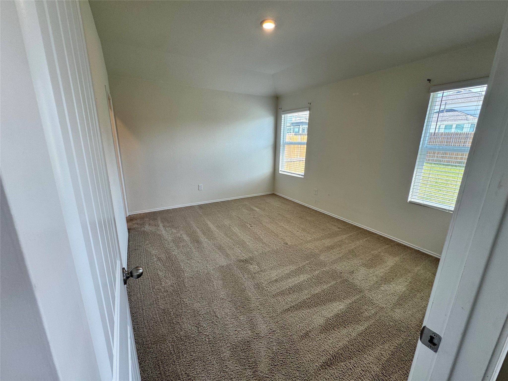 11820 Rush Lane Elgin, TX 78621 - Photo 5 of 31 A well-lit bedroom with fresh carpeting awaits your personal touch.