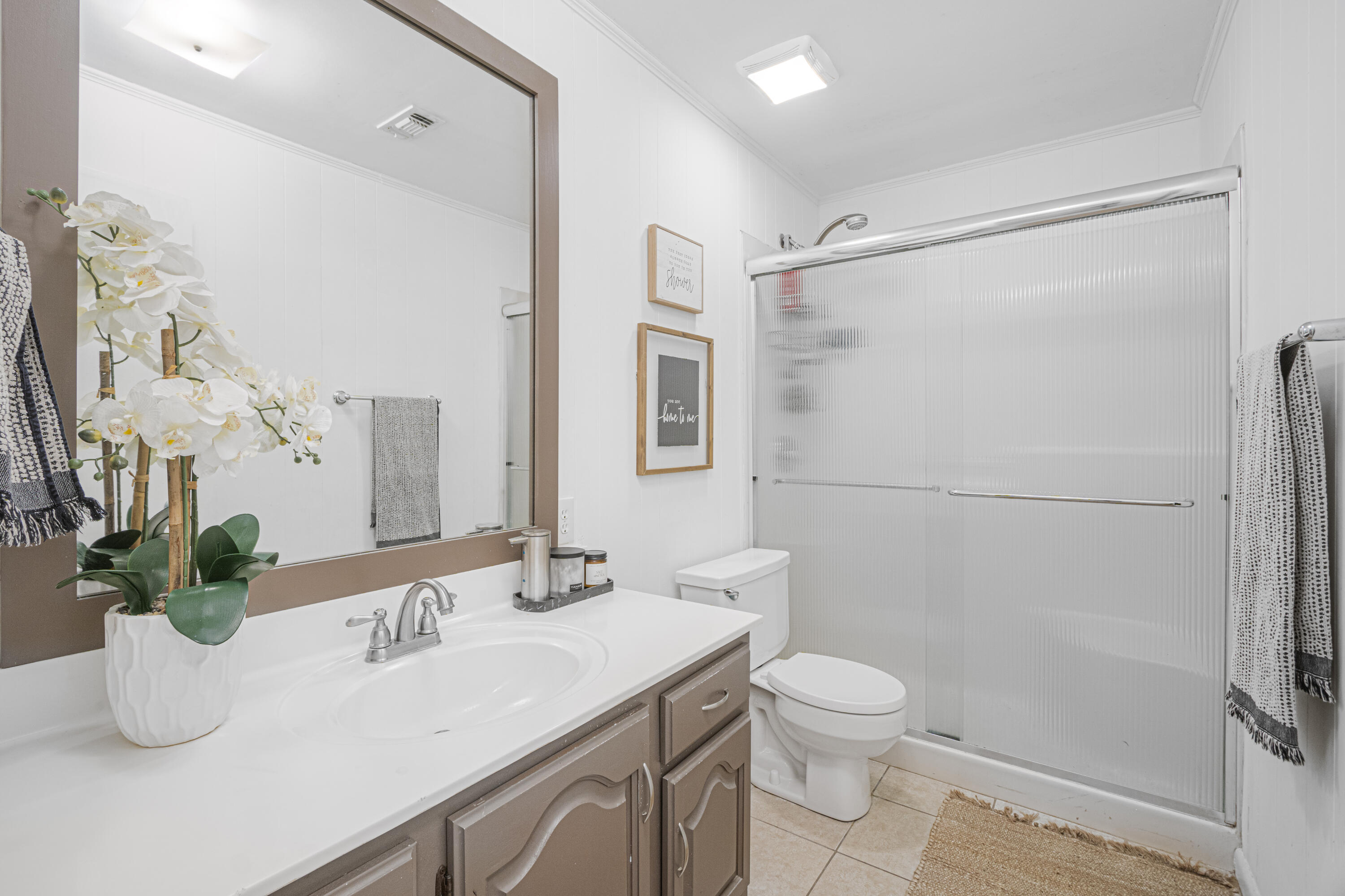 19228 Highway 331 Freeport, FL 32439 - Photo 15 of 26 a bathroom with a granite countertop sink a toilet and shower