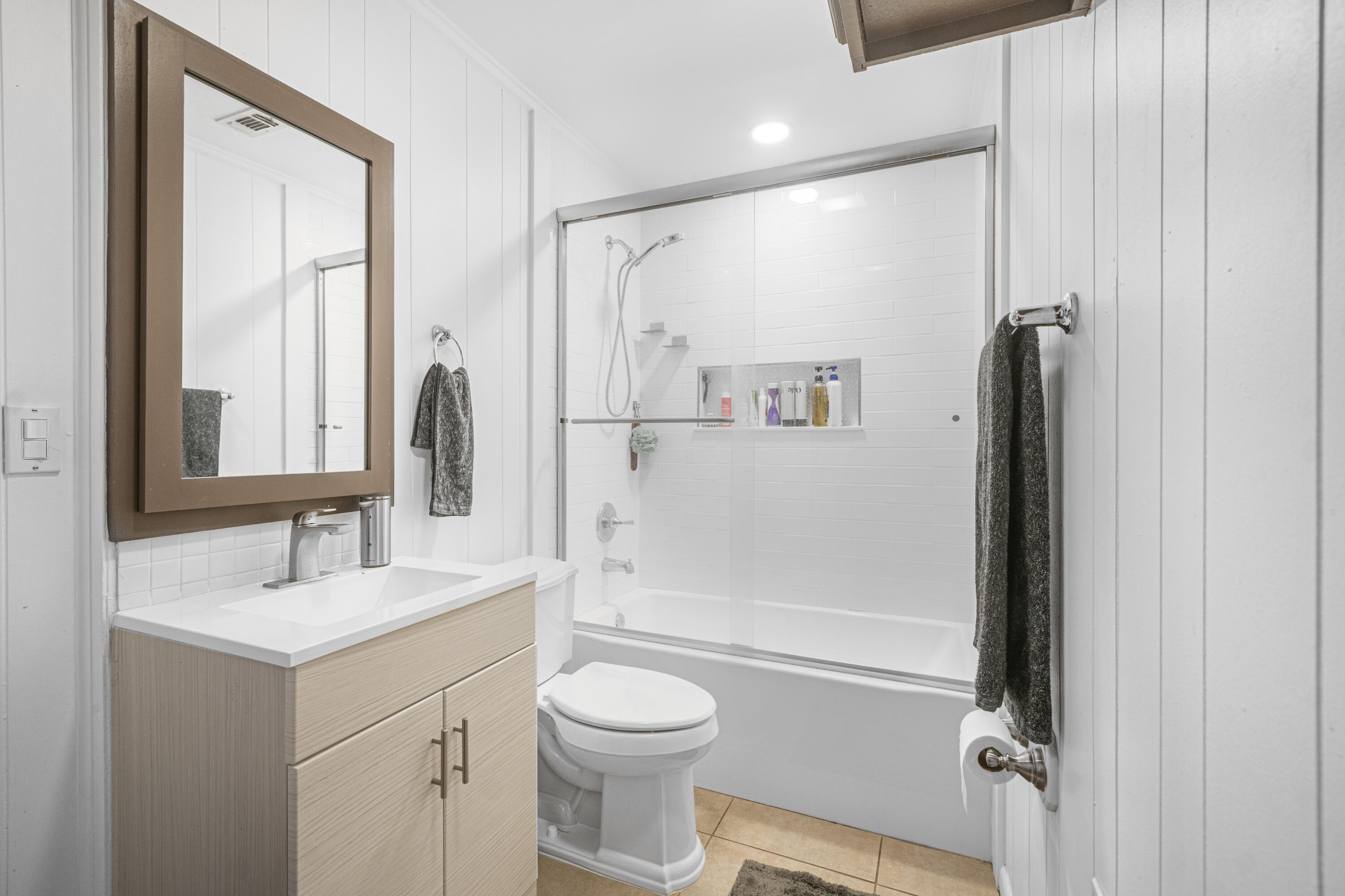 19228 Highway 331 Freeport, FL 32439 - Photo 17 of 26 a bathroom with a granite countertop sink toilet and shower
