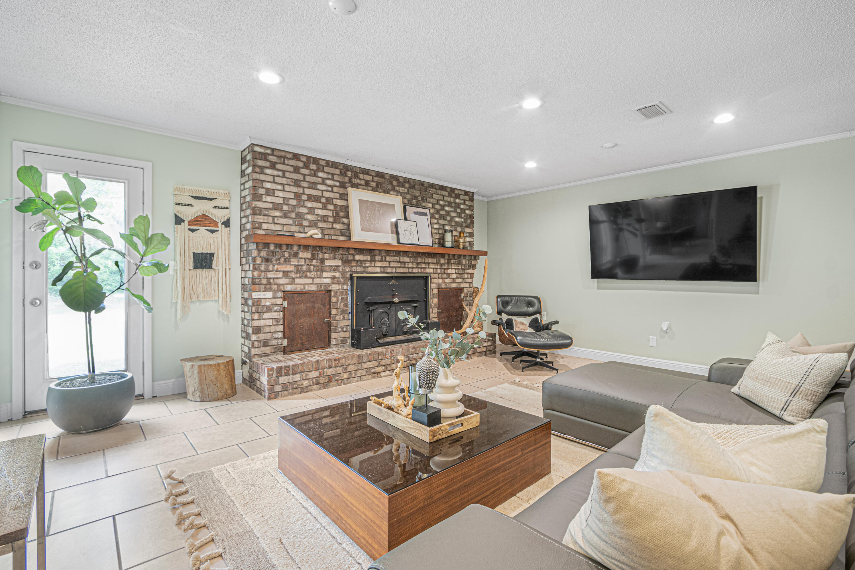 19228 Highway 331 Freeport, FL 32439 - Photo 19 of 26 a living room with furniture a fireplace and a flat screen tv