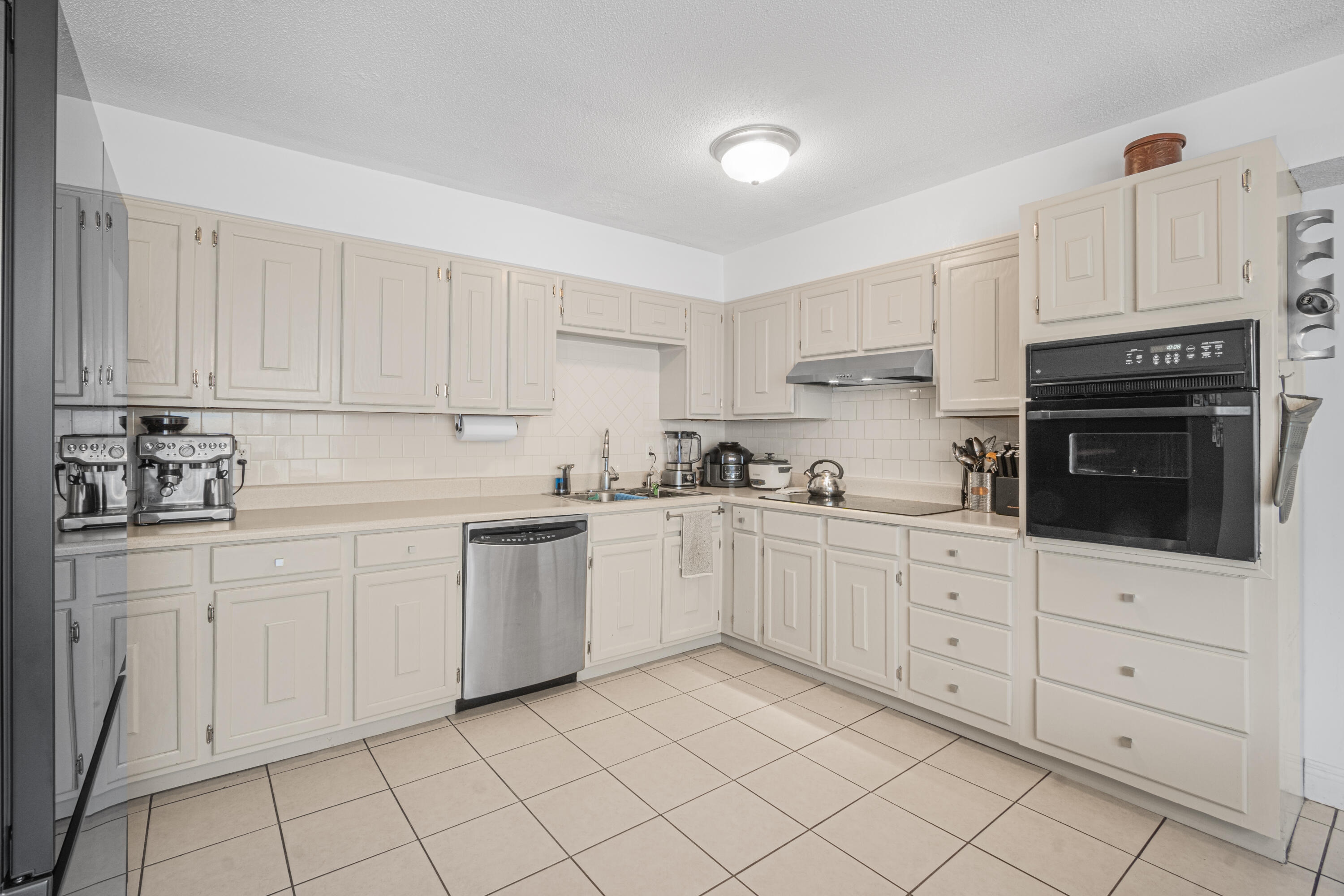 19228 Highway 331 Freeport, FL 32439 - Photo 20 of 26 a kitchen with white cabinets a sink and dishwasher