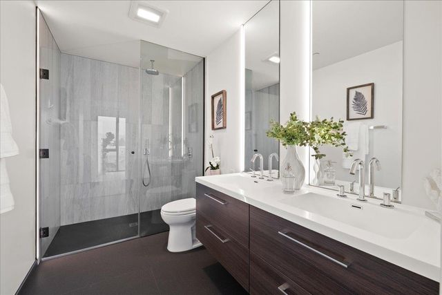 a bedroom with a bed and lamps