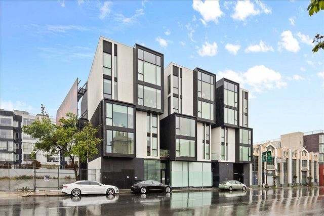 a view of a room with wooden floor and windows