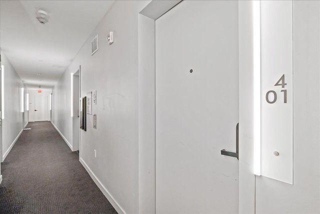 a large kitchen with stainless steel appliances kitchen island granite countertop a large island in the center