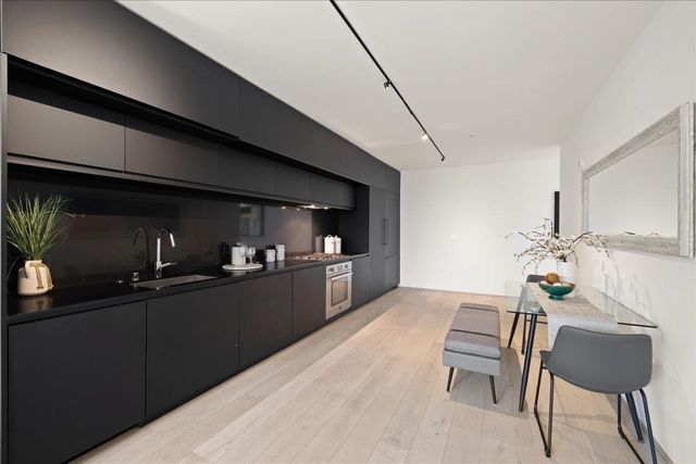 a kitchen with a stove and white cabinets