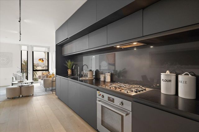 a living room with furniture and a painting on the wall