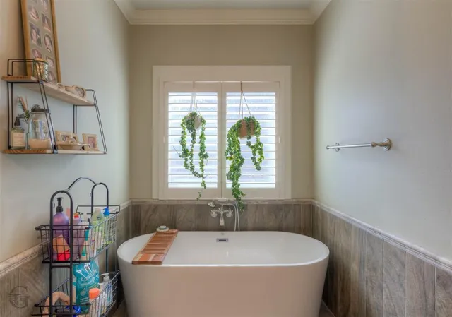 a bathroom with a bathtub and a window